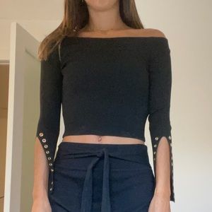 black off the shoulder knit with grommet cuff detail